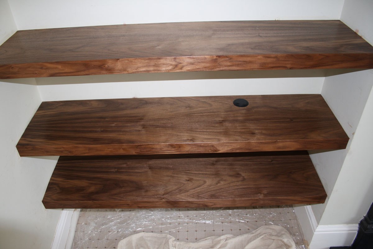 Walnut shelves fitted into an alcove